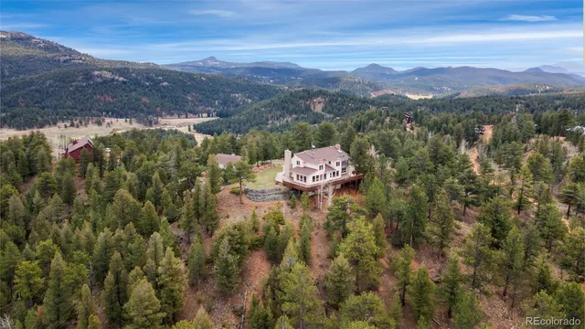 aerial view of a house with a mountain