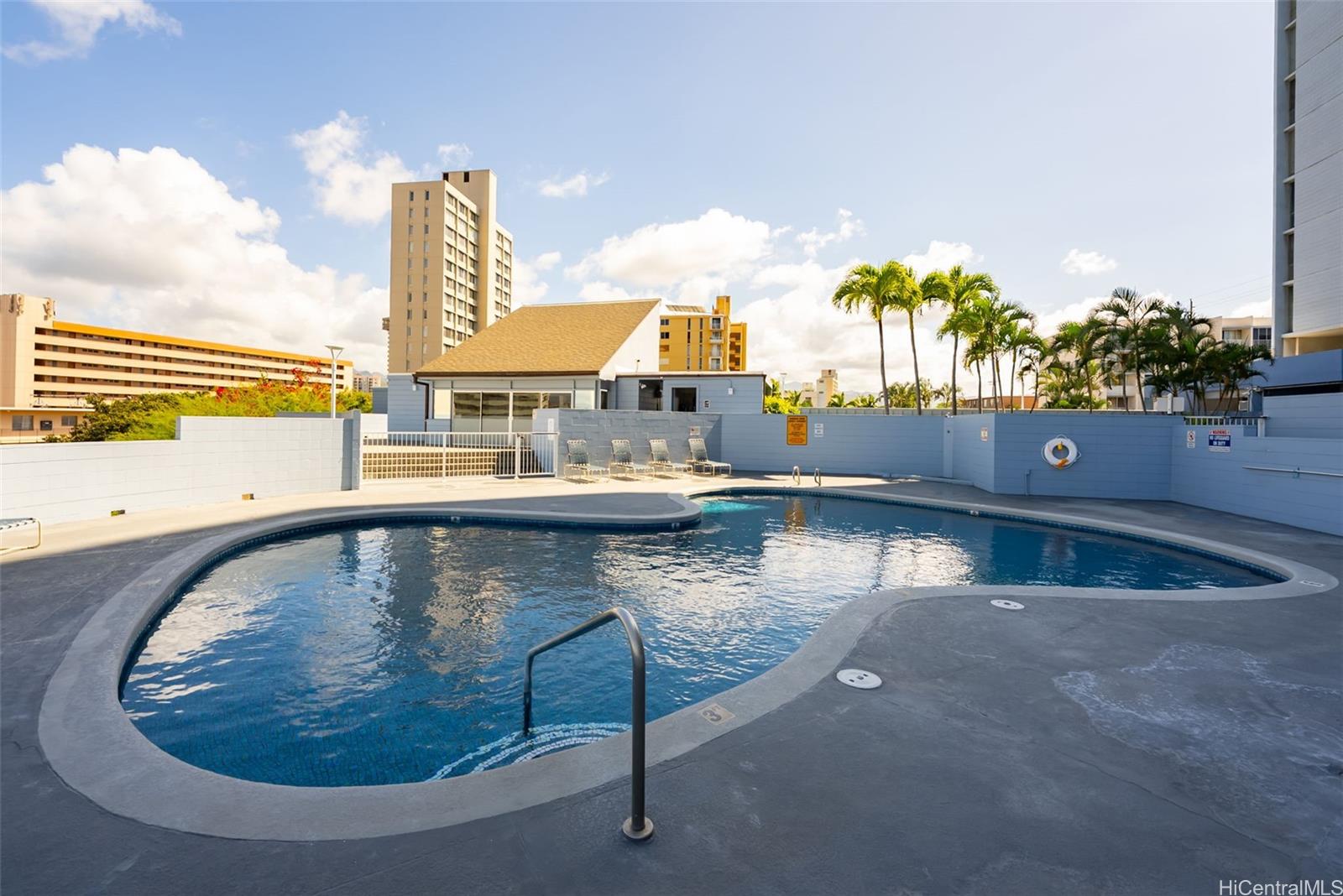 3045 Ala Napuaa Place, Unit 1305 Honolulu, HI 96818 - Photo 16 of 18 a view of a swimming pool with a yard