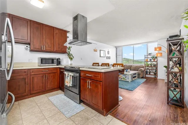 a kitchen with stainless steel appliances granite countertop a sink dishwasher stove and refrigerator with wooden floor
