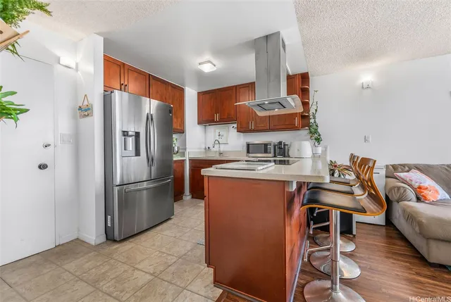 a kitchen with stainless steel appliances granite countertop a refrigerator and a stove top oven