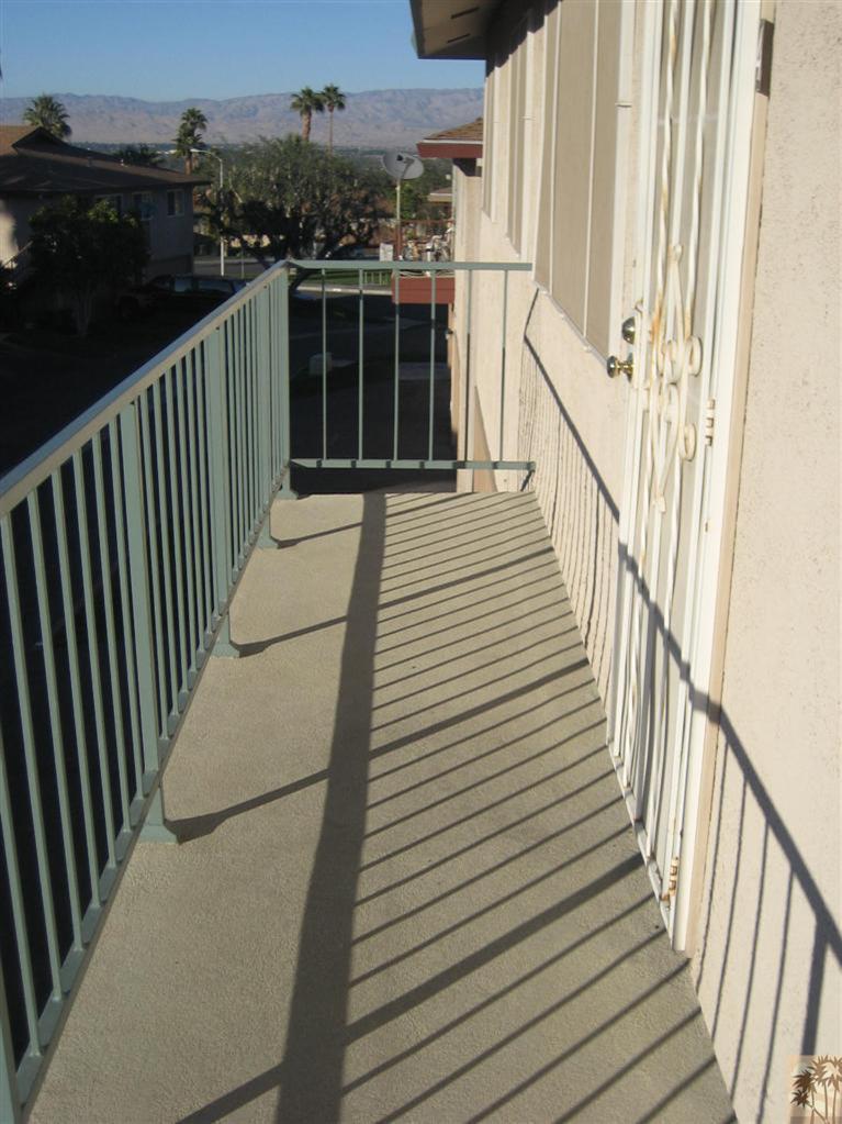 72710 Eagle Road, Unit 4 Palm Desert, CA 92260 - Photo 2 of 9 a view of a balcony with wooden floor
