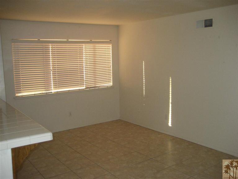 72710 Eagle Road, Unit 4 Palm Desert, CA 92260 - Photo 4 of 9 a view of an empty room with a window