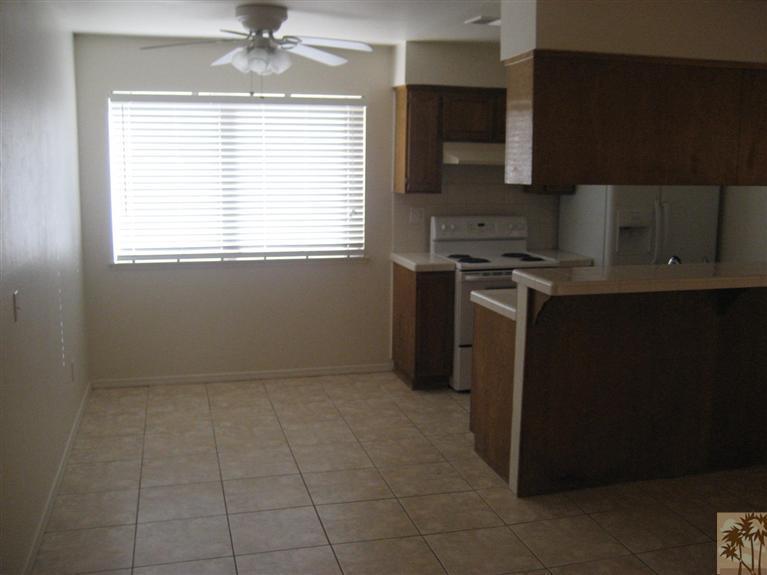 72710 Eagle Road, Unit 4 Palm Desert, CA 92260 - Photo 6 of 9 a kitchen with a stove a sink and a microwave