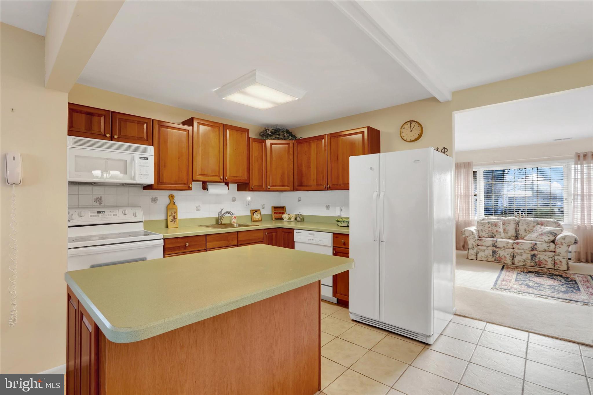 15 Cable Road Levittown, PA 19057 - Photo 6 of 16 Inviting kitchen with warm wooden accents.