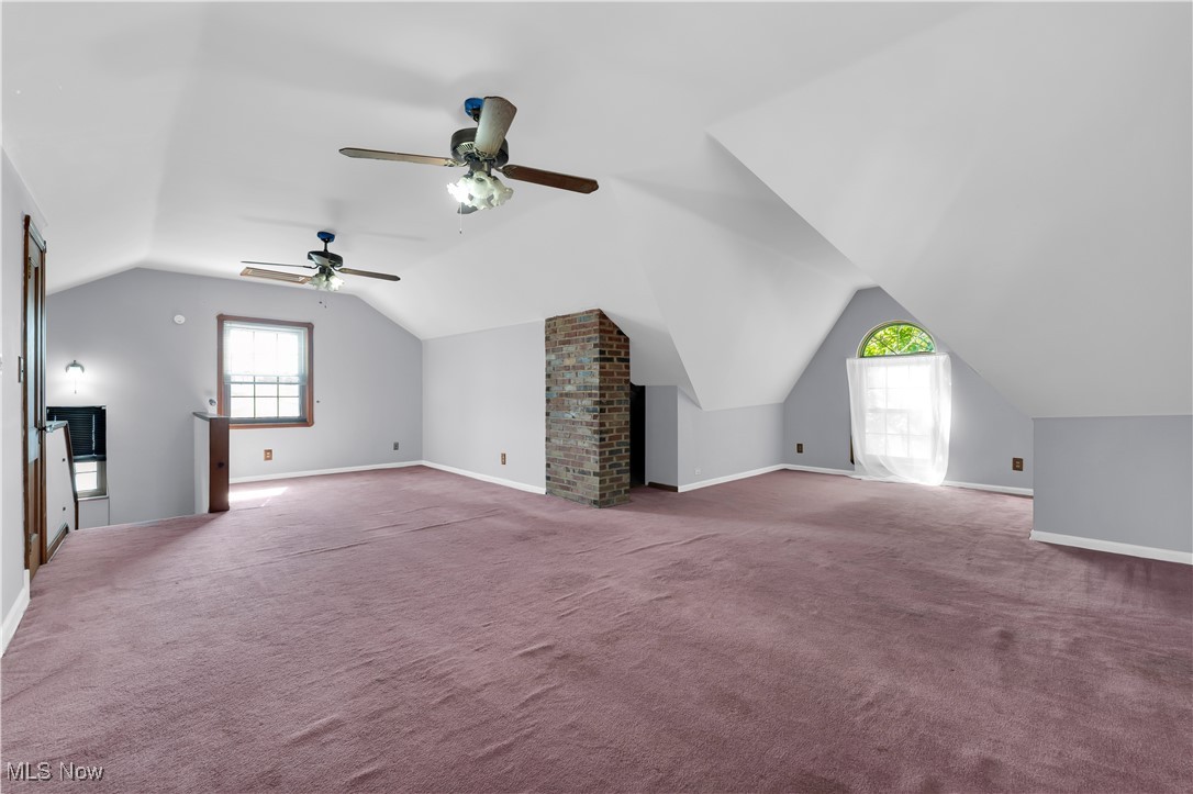 3739 Warren Road Cleveland, OH 44111 - Photo 23 of 40 Bonus room with vaulted ceiling, carpet floors, and ceiling fan