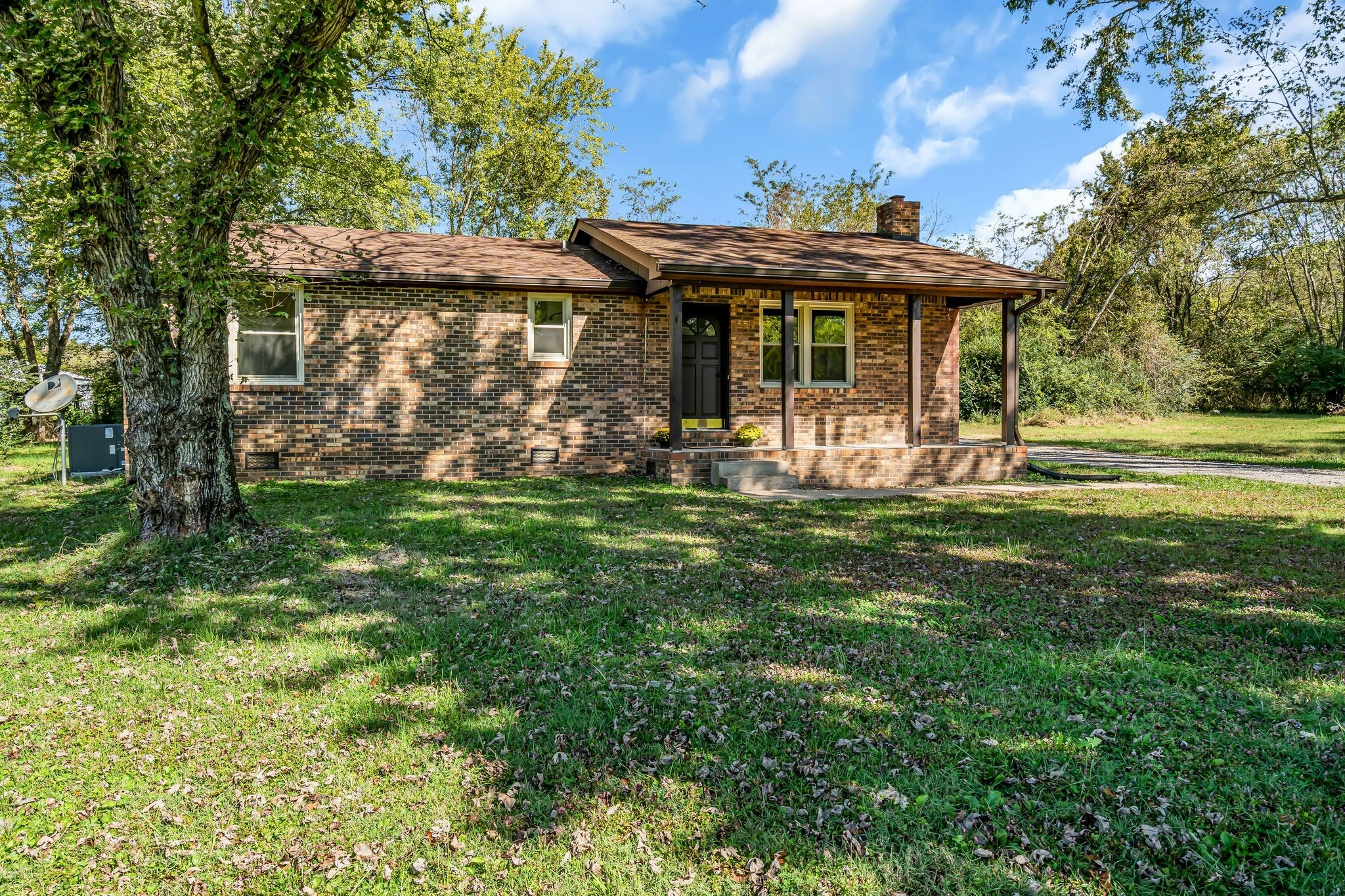 955 Hamilton Chambers Road Lebanon, TN 37087 - Photo 1 of 30 a front view of a house with a yard table and chairs