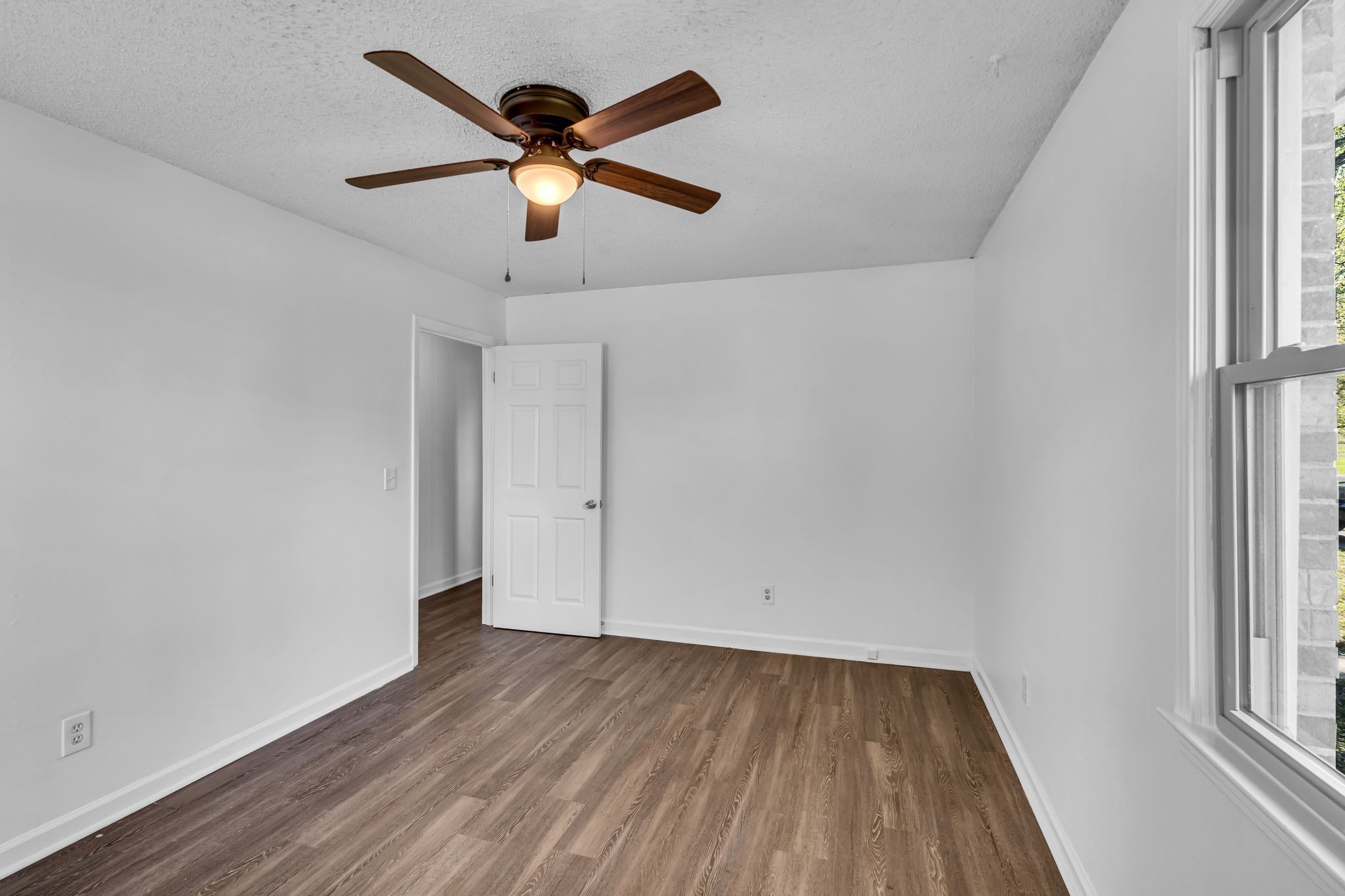 955 Hamilton Chambers Road Lebanon, TN 37087 - Photo 15 of 30 an empty room with wooden floor and windows