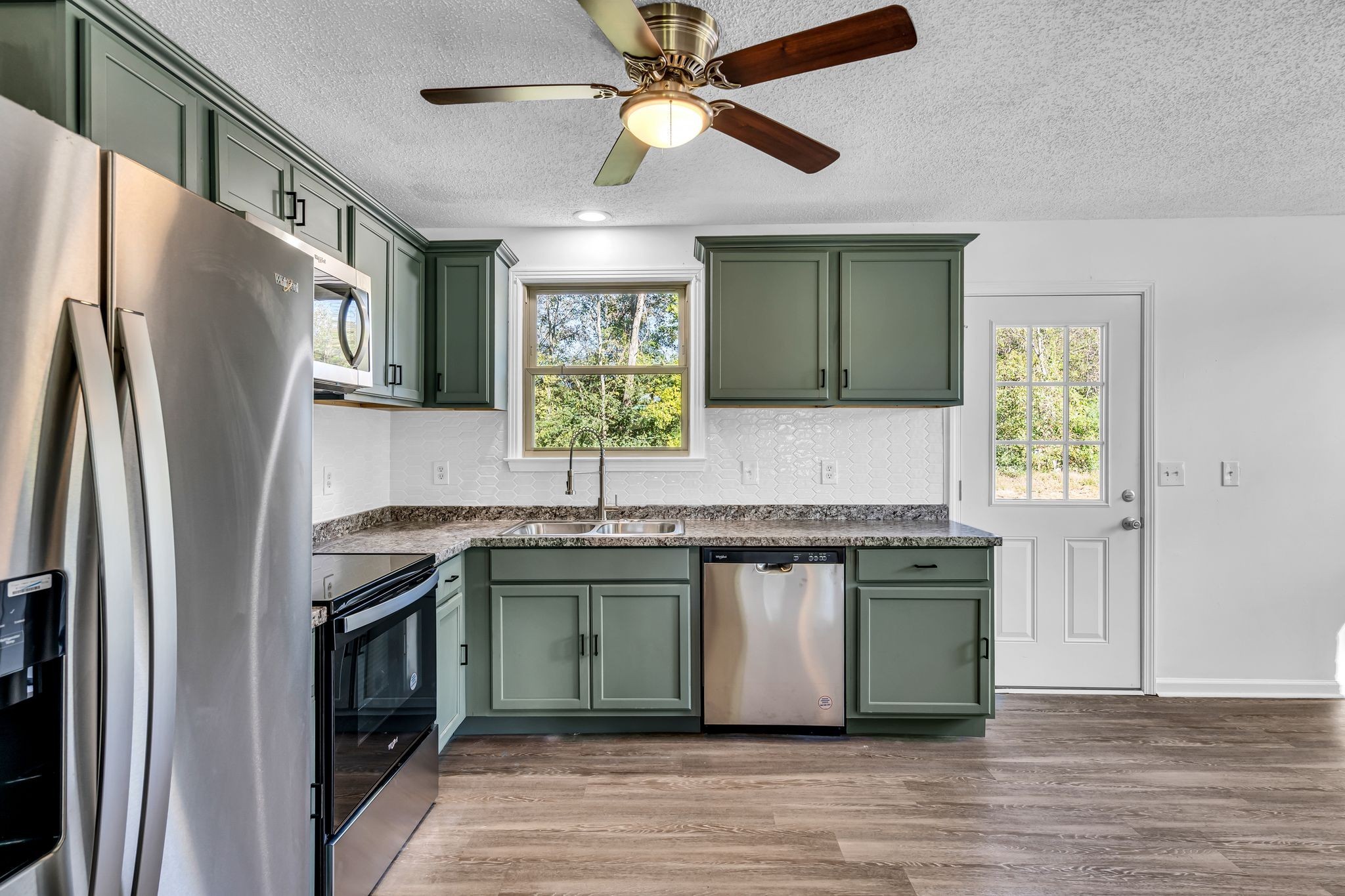 955 Hamilton Chambers Road Lebanon, TN 37087 - Photo 7 of 30 a kitchen with stainless steel appliances granite countertop a refrigerator a sink and a stove