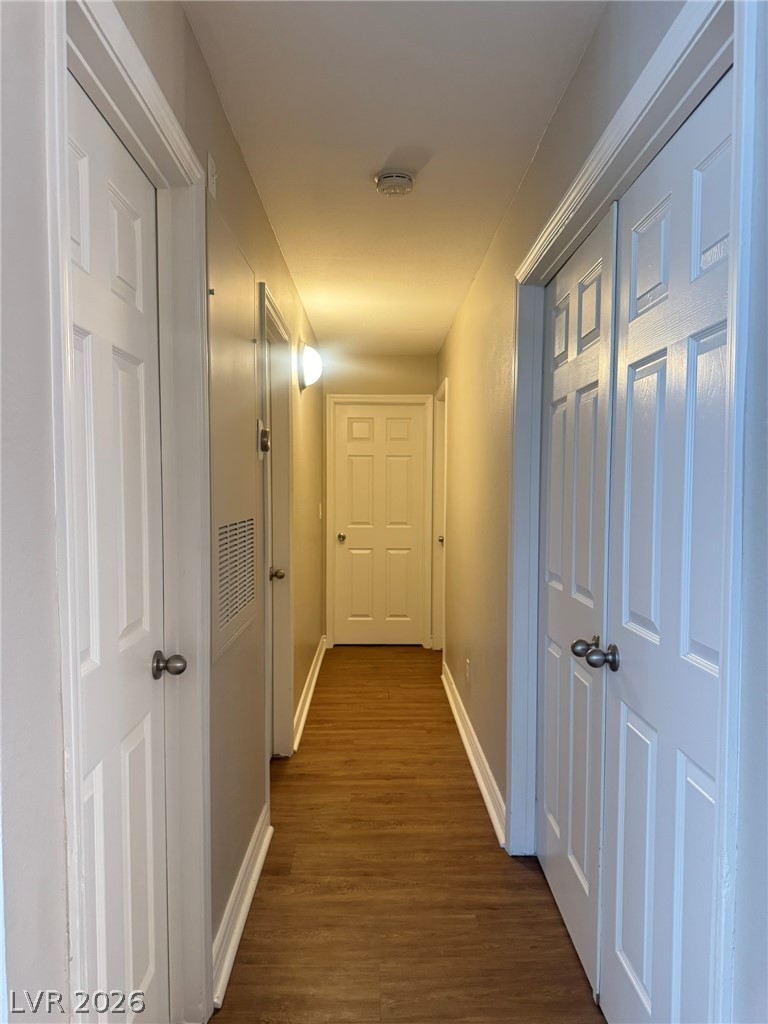 5141 South Lindell Road, Unit 102 Las Vegas, NV 89118 - Photo 9 of 17 A well-lit passage connecting living spaces, featuring resilient flooring and crisp white trim.