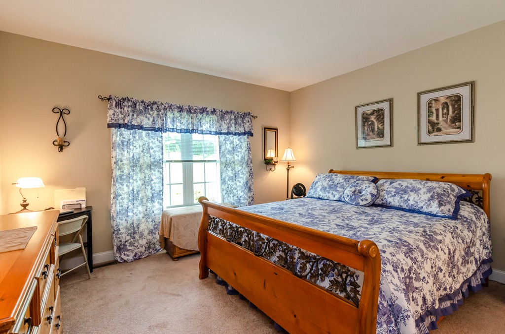 2 Thorn Hill Road, Unit 2 Hooksett, NH 03106 - Photo 17 of 27 a bed room with a bed and a window