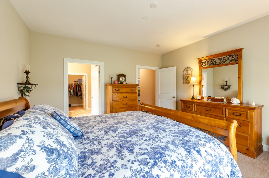 2 Thorn Hill Road, Unit 2 Hooksett, NH 03106 - Photo 19 of 27 a bedroom with a bed and a dresser