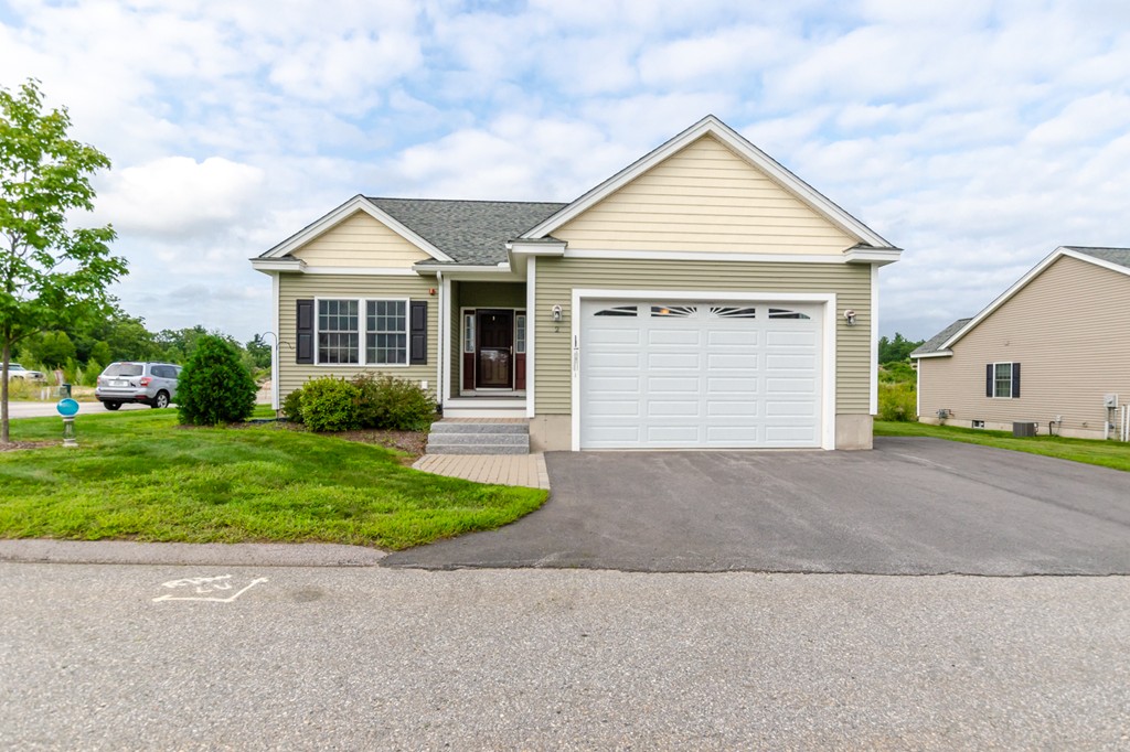 2 Thorn Hill Road, Unit 2 Hooksett, NH 03106 - Photo 2 of 27 a front view of a house with a yard and garage