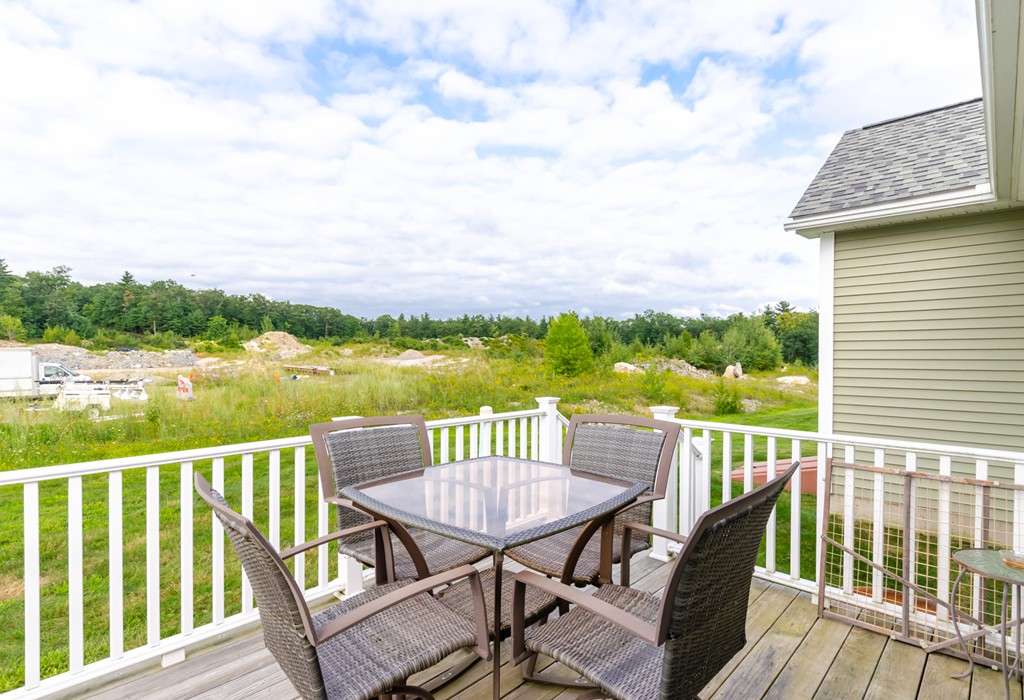 2 Thorn Hill Road, Unit 2 Hooksett, NH 03106 - Photo 23 of 27 a view of a chairs and table on the deck