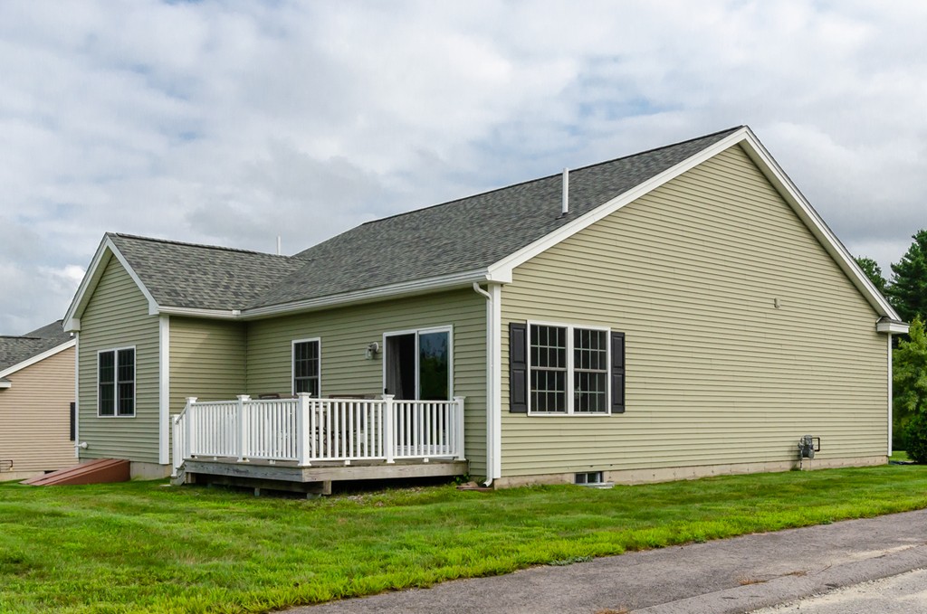 2 Thorn Hill Road, Unit 2 Hooksett, NH 03106 - Photo 25 of 27 a front view of a house with a yard and wooden fence