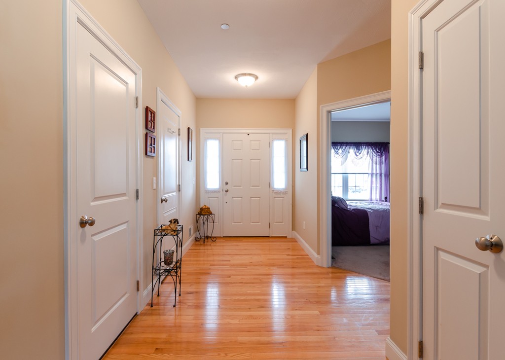 2 Thorn Hill Road, Unit 2 Hooksett, NH 03106 - Photo 4 of 27 a view of a hallway with wooden floor and windows