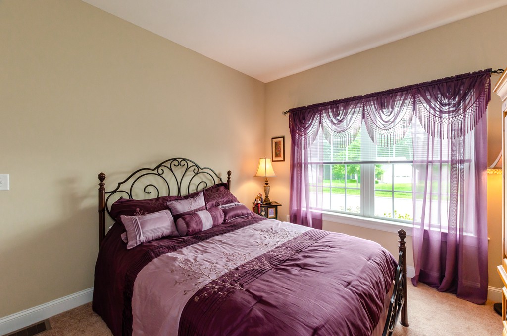 2 Thorn Hill Road, Unit 2 Hooksett, NH 03106 - Photo 5 of 27 a bedroom with a large bed and a window