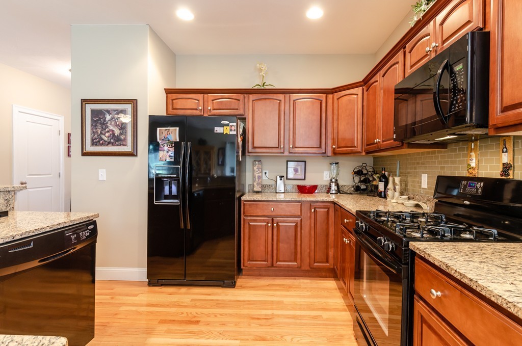 2 Thorn Hill Road, Unit 2 Hooksett, NH 03106 - Photo 9 of 27 a kitchen with stainless steel appliances granite countertop a refrigerator stove top oven and sink