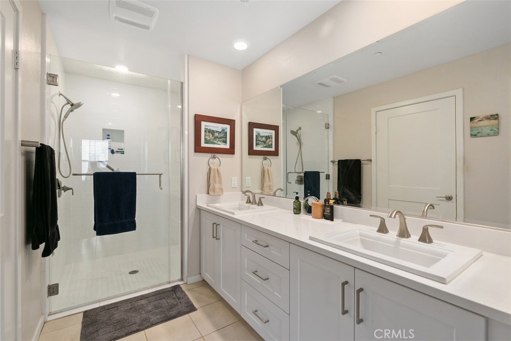 229 Carlow Irvine, CA 92618 - Photo 12 of 32 a bathroom with double vanity sink and mirror