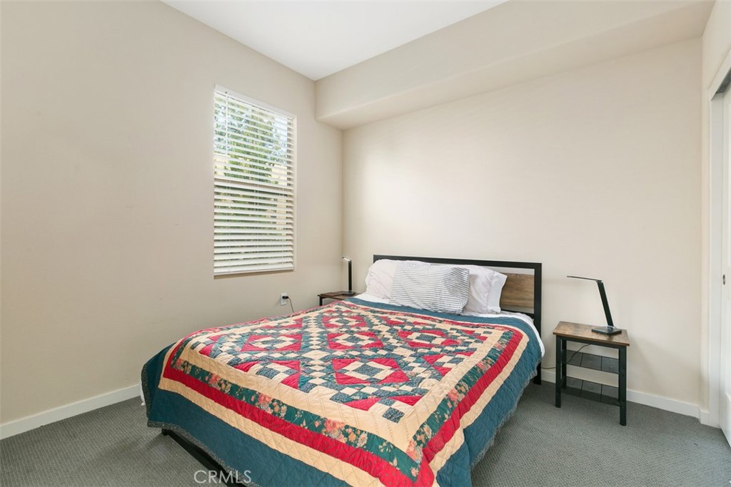 229 Carlow Irvine, CA 92618 - Photo 13 of 32 a bedroom with a bed a lamp and a desk
