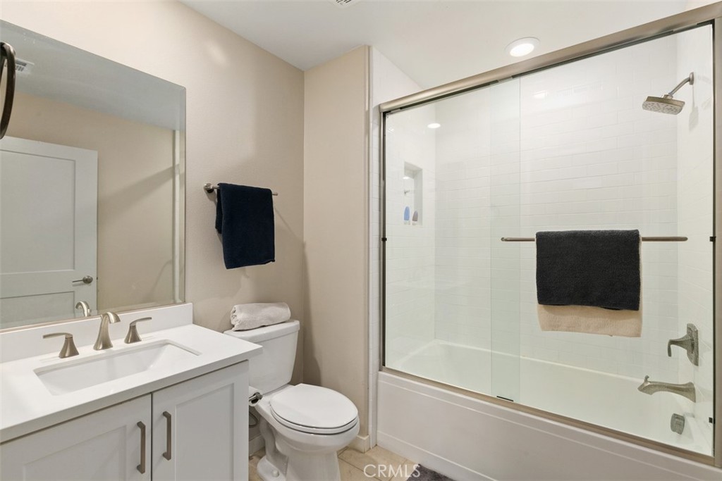 229 Carlow Irvine, CA 92618 - Photo 14 of 32 a bathroom with a granite countertop sink toilet and shower