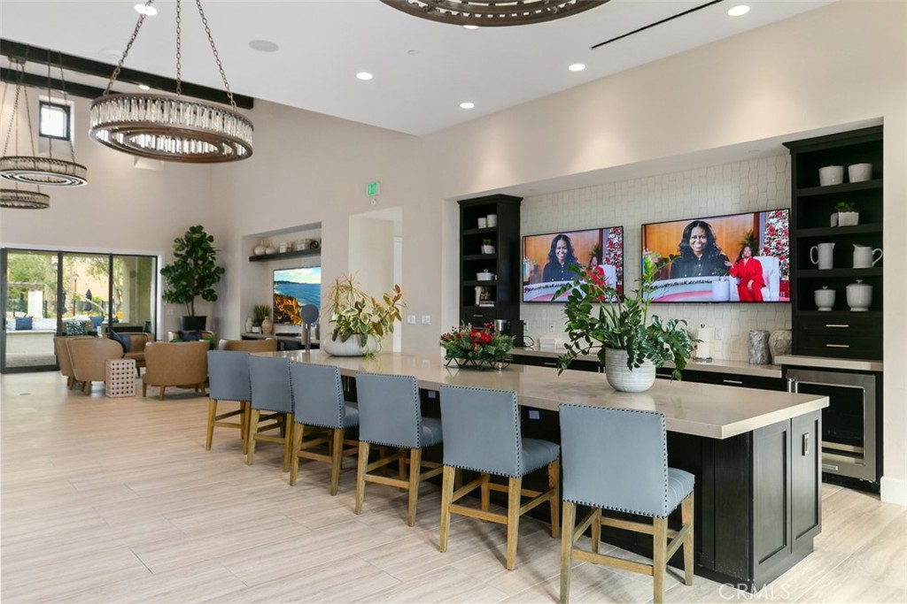 229 Carlow Irvine, CA 92618 - Photo 21 of 32 a dining room with wooden floor a chandelier a wooden table and chairs