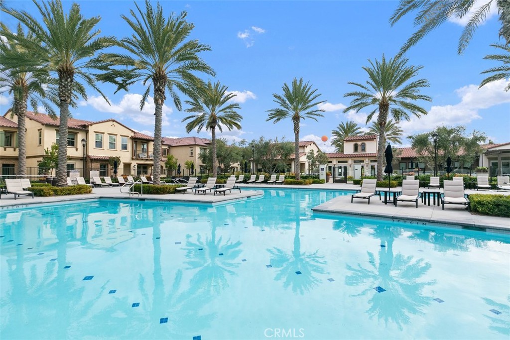 229 Carlow Irvine, CA 92618 - Photo 27 of 32 a view of swimming pool with table and chairs water fall and palm tree