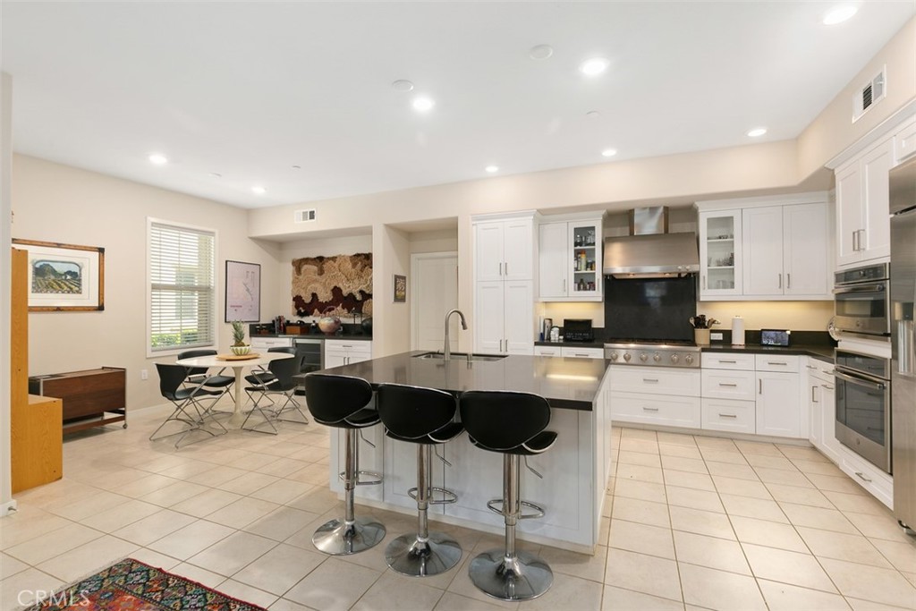 229 Carlow Irvine, CA 92618 - Photo 3 of 32 a kitchen with stainless steel appliances kitchen island granite countertop a sink and cabinets