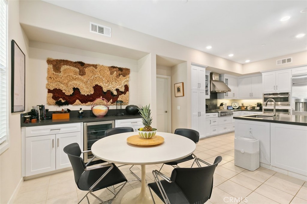 229 Carlow Irvine, CA 92618 - Photo 4 of 32 a kitchen with stainless steel appliances kitchen island granite countertop a table and chairs