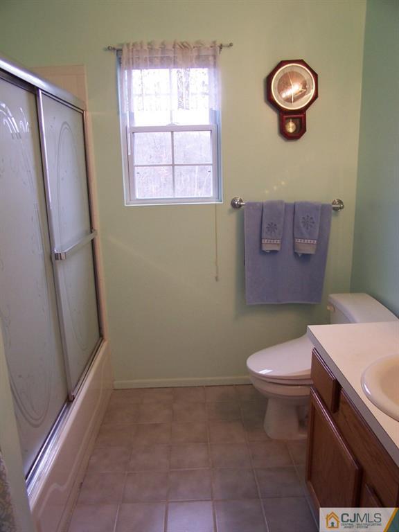 9 Westley Road Old Bridge, NJ 08857 - Photo 14 of 16 a bathroom with a toilet a sink and a window