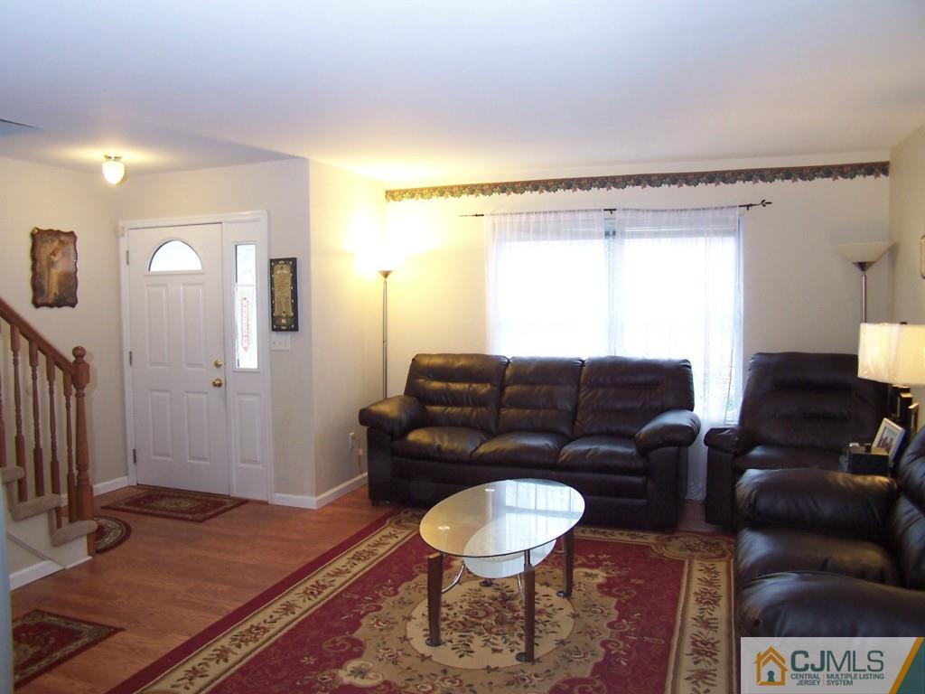 9 Westley Road Old Bridge, NJ 08857 - Photo 4 of 16 a living room with a couch and a coffee table