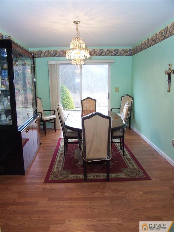 9 Westley Road Old Bridge, NJ 08857 - Photo 5 of 16 a view of a dining room with furniture a chandelier and wooden floor