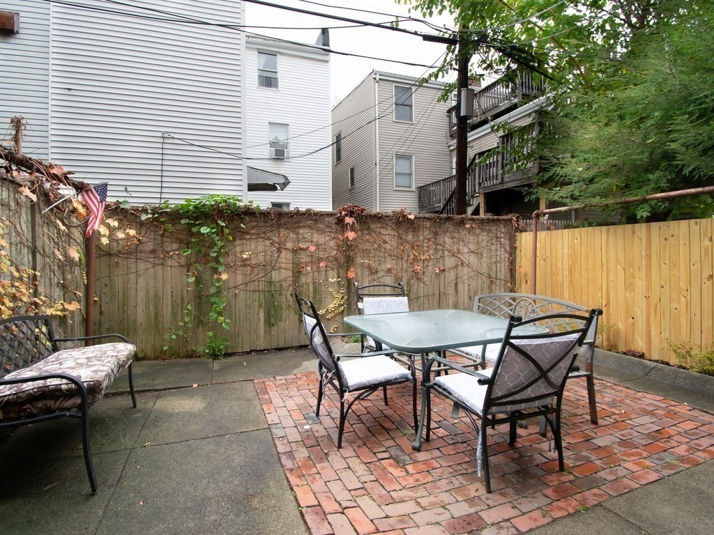 a backyard of a house with table and chairs