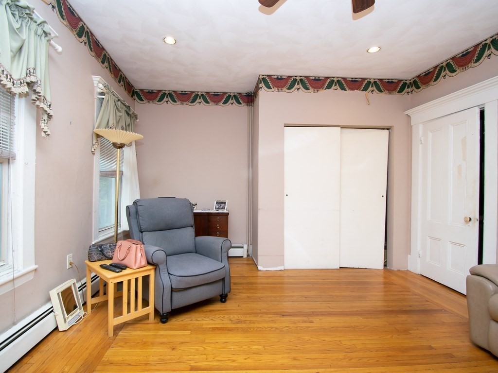 100 Elm Street Boston, MA 02129 - Photo 16 of 18 a living room with furniture and a wooden floor