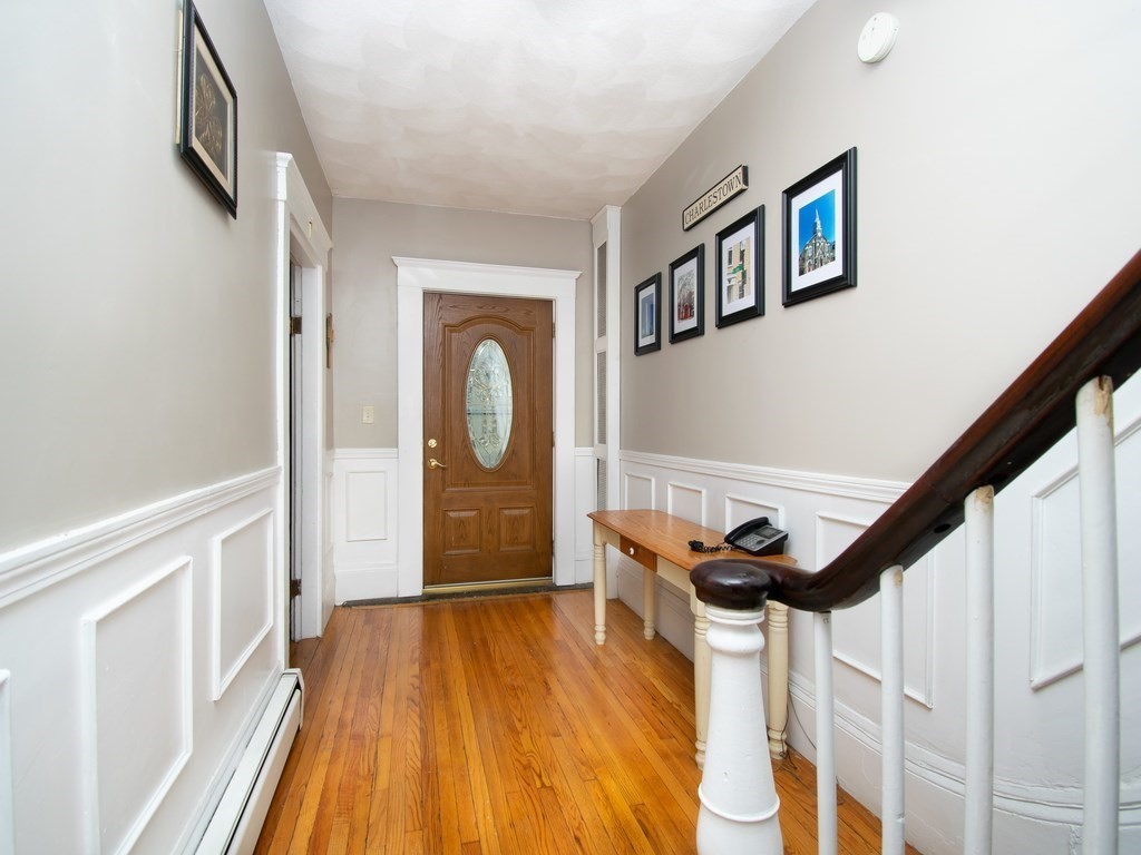 100 Elm Street Boston, MA 02129 - Photo 3 of 18 a view of entryway with wooden floor and stairs