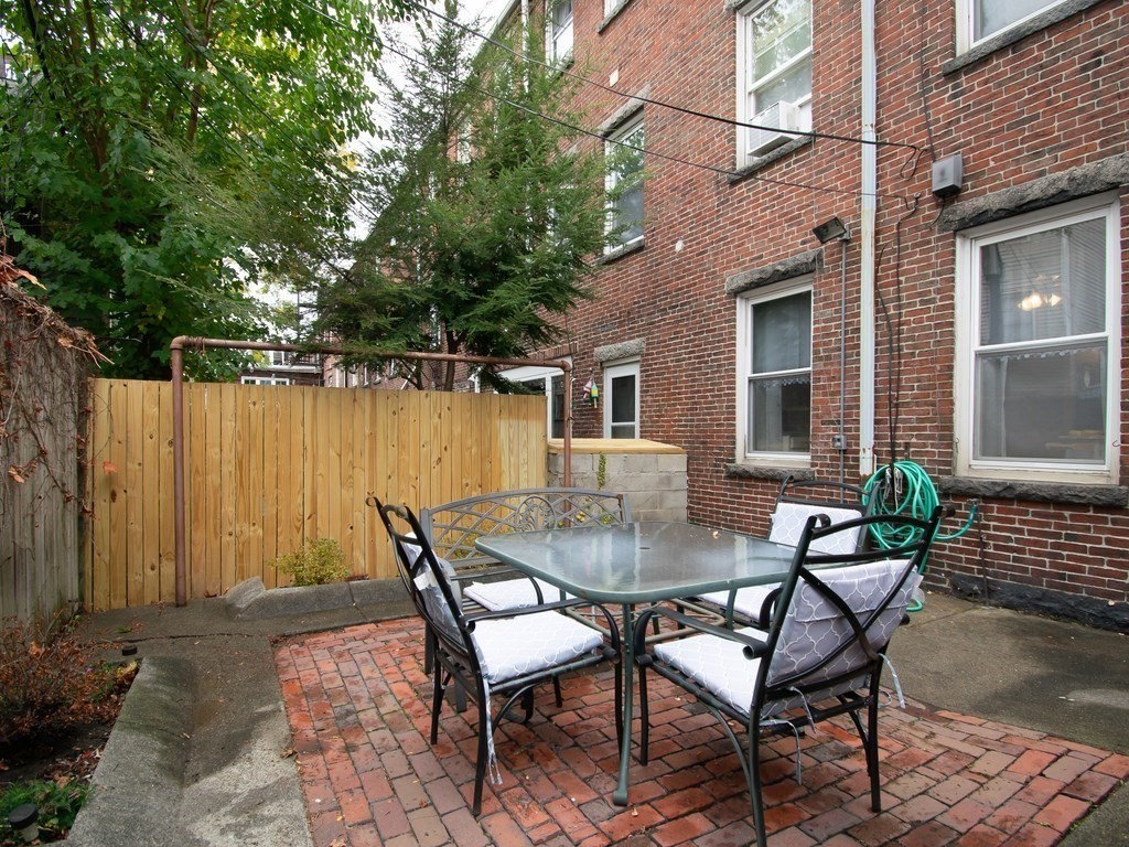 100 Elm Street Boston, MA 02129 - Photo 7 of 18 a backyard of a house with table and chairs