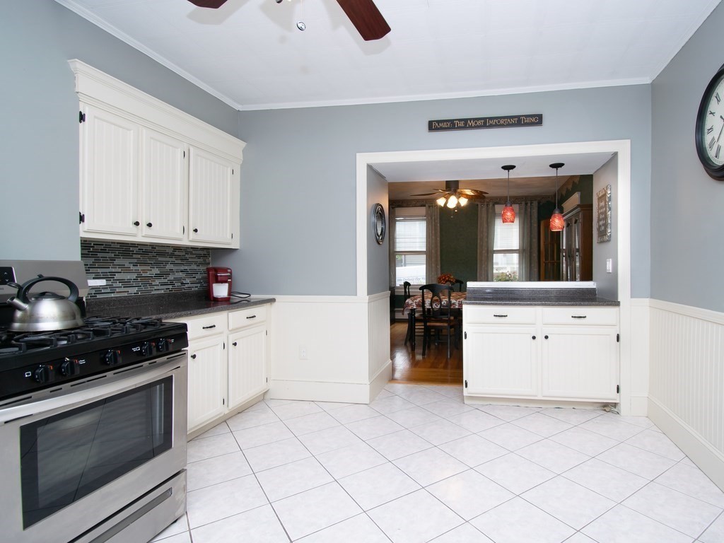 100 Elm Street Boston, MA 02129 - Photo 8 of 18 a kitchen with white cabinets and appliances