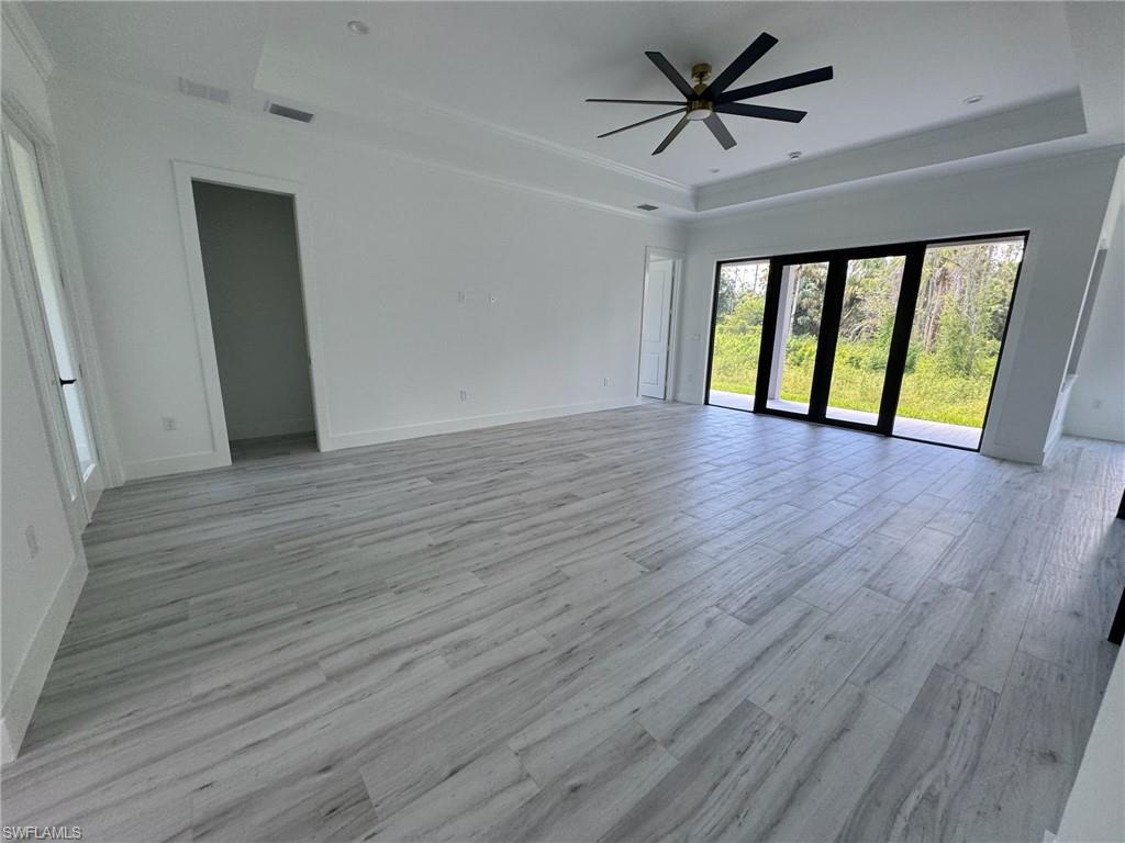 308 Golden Gate Boulevard East Naples, FL 34117 - Photo 13 of 29 wooden floor in an empty room with a window