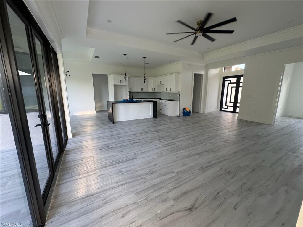 308 Golden Gate Boulevard East Naples, FL 34117 - Photo 14 of 29 an empty room with wooden floor and stainless steel appliances