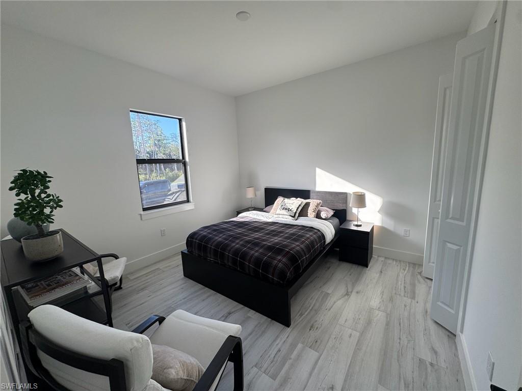 308 Golden Gate Boulevard East Naples, FL 34117 - Photo 20 of 29 a bedroom with a bed and a chair