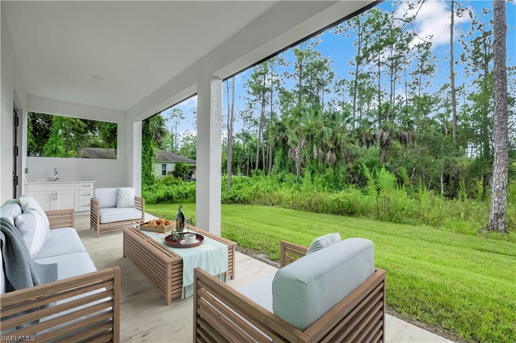 308 Golden Gate Boulevard East Naples, FL 34117 - Photo 26 of 29 a view of a patio with couches chairs and a big yard