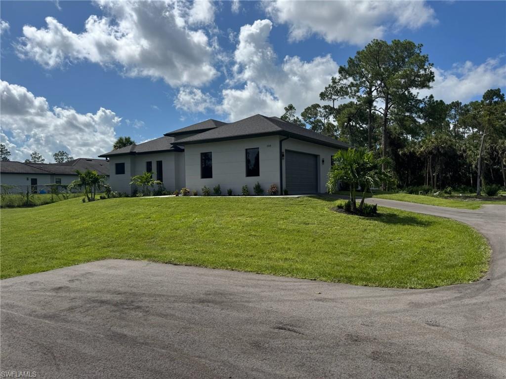 308 Golden Gate Boulevard East Naples, FL 34117 - Photo 4 of 29 a front view of house with yard and green space