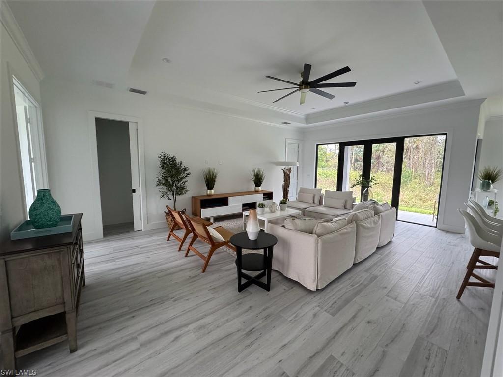 308 Golden Gate Boulevard East Naples, FL 34117 - Photo 6 of 29 a living room with furniture and a wooden floor