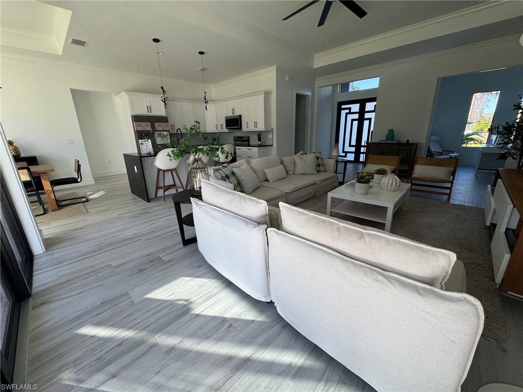 308 Golden Gate Boulevard East Naples, FL 34117 - Photo 7 of 29 a living room with furniture and a wooden floor