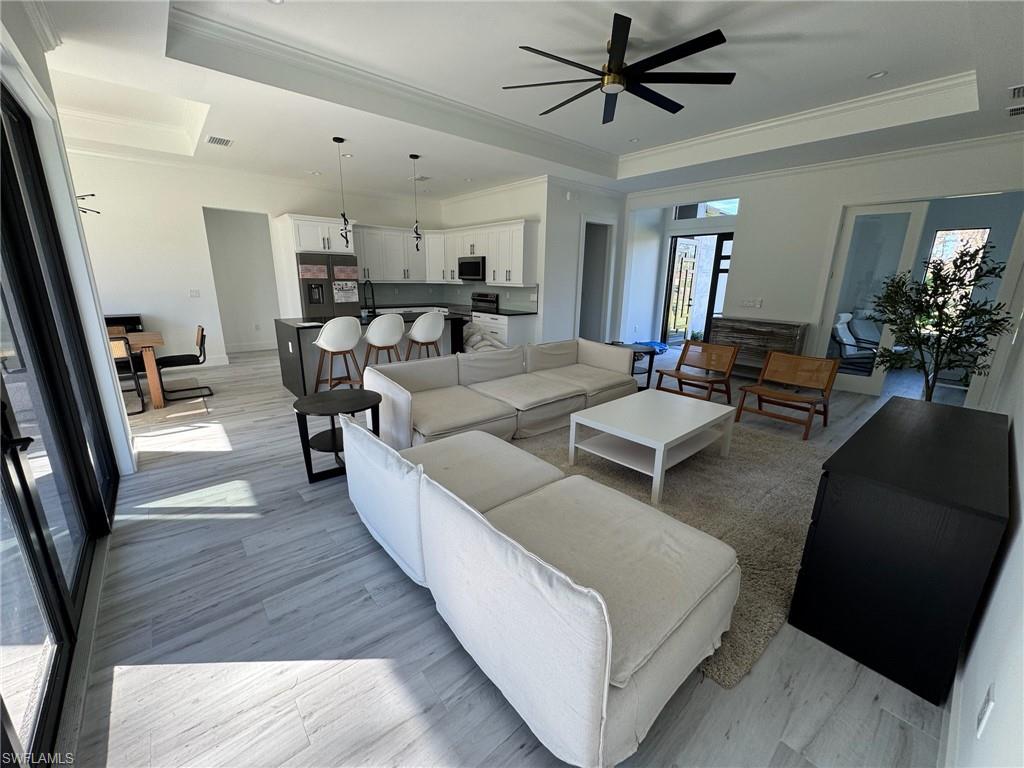 308 Golden Gate Boulevard East Naples, FL 34117 - Photo 8 of 29 a living room with furniture and a chandelier