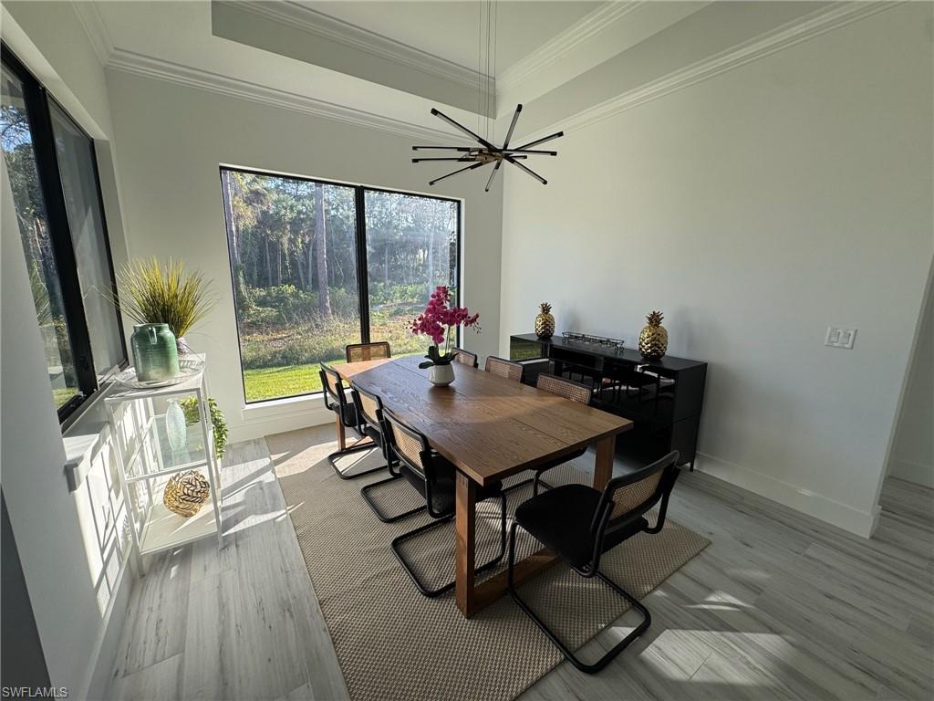 308 Golden Gate Boulevard East Naples, FL 34117 - Photo 9 of 29 a view of a dining room with furniture window and wooden floor