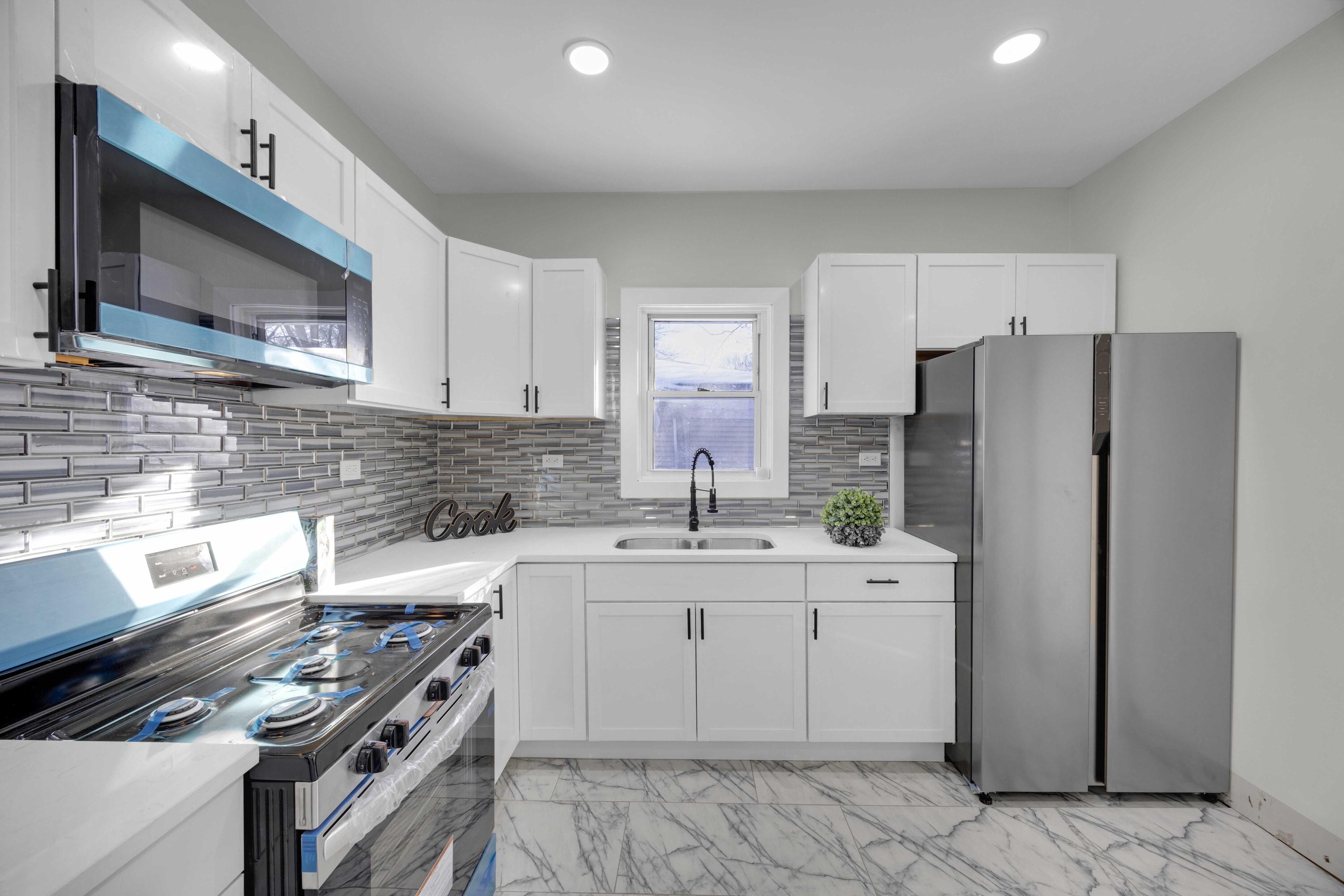 4200 Monroe Street Gary, IN 46408 - Photo 10 of 25 a kitchen with a sink stove and refrigerator