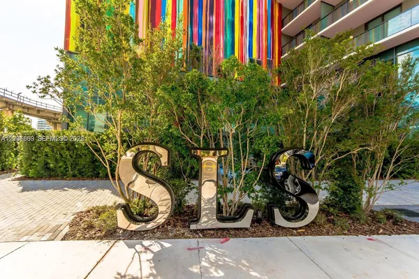 a view of a backyard with plants and a slide