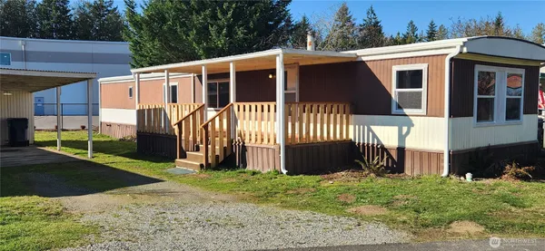 a view of a house with a yard and pathway