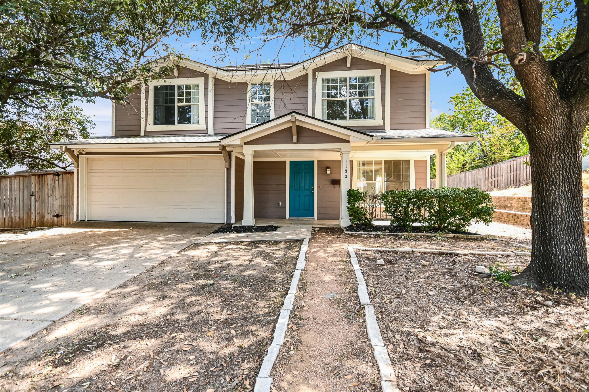 a front view of a house with garden