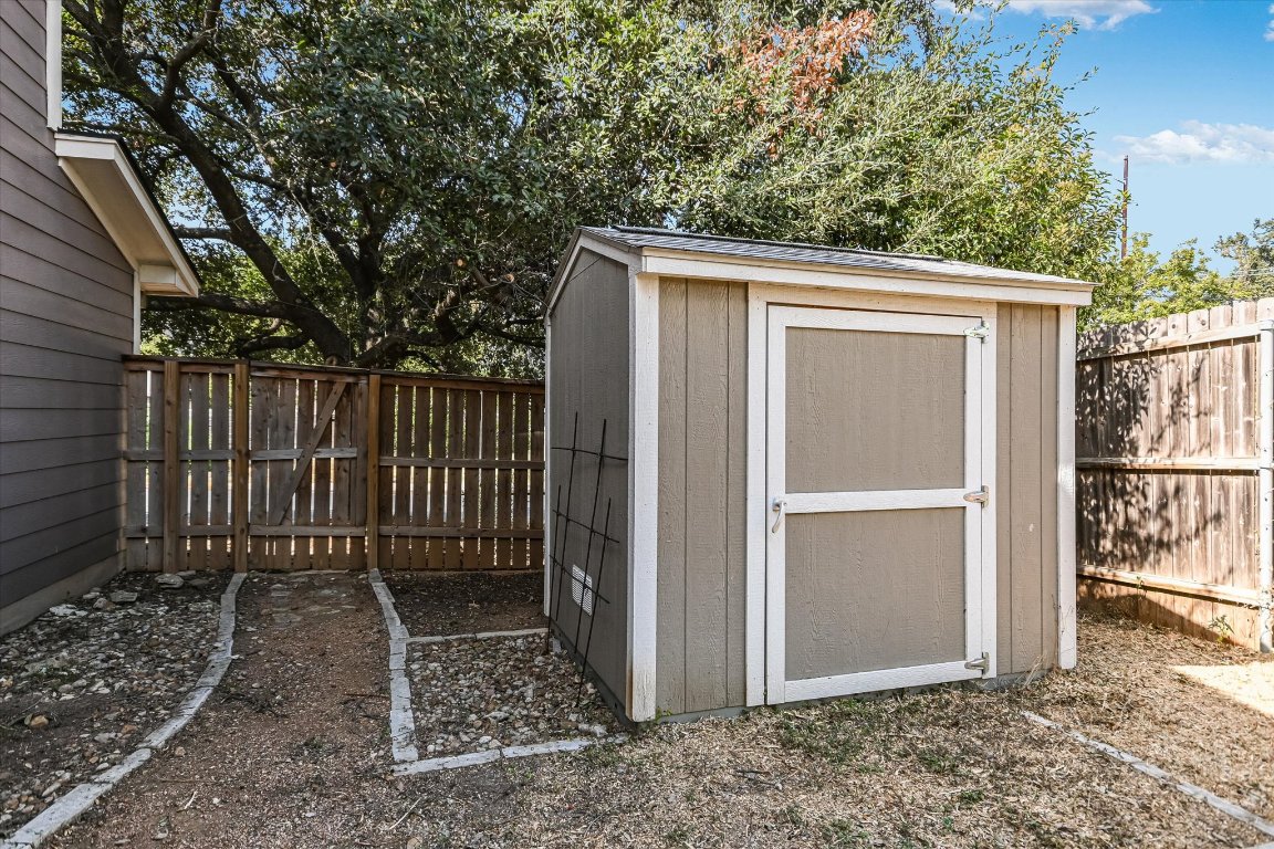 1193 Curve Street Austin, TX 78702 - Photo 18 of 18 a view of backyard with small cabin and wooden fence